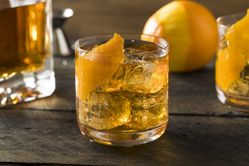 Boozy Homemade Old Fashioned Bourbon on the Rocks with an Orange Garnish